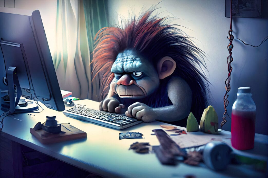 Internet troll - online troll in a dusky bedroom angrily focused on writing hateful comments. | Meridian Source