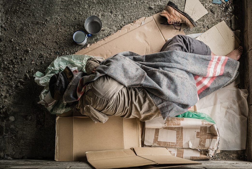 Old,Homeless,Man,Wearing,Sweater,And,Blanket,Sleeping,On,Cardboard | Meridian Source