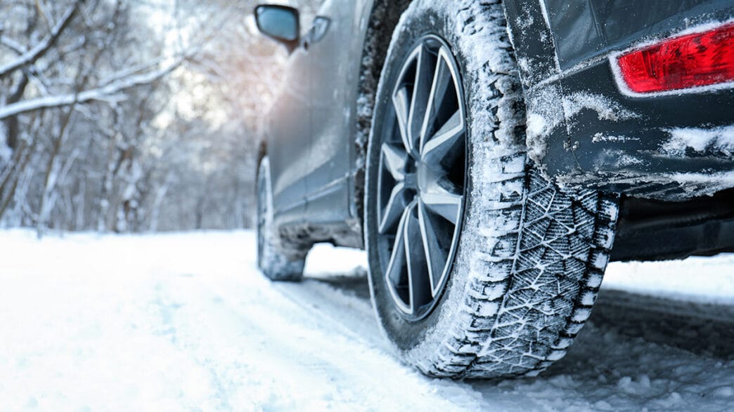 Snowy country road with car on winter day closeup Space for te | Meridian Source