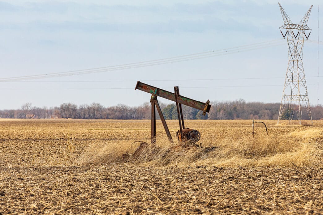 Old orphaned oil well pump in farm field oil well abandonment | Meridian Source