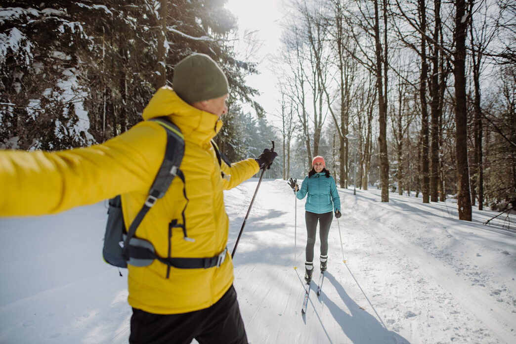 Senior couple skiing together in the middle of forest | Meridian Source