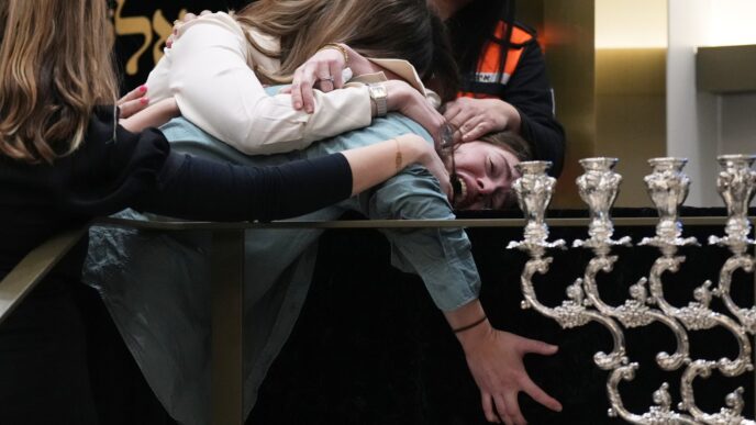 Funerals for people slain in Australian antisemitic mass shooting begin as suspected gunman charged