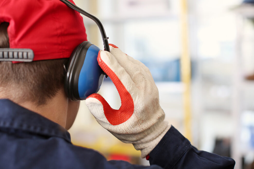 Male worker with hearing protectors indoors | Meridian Source