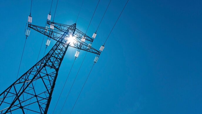 electricity pylon with sun and sky | Meridian Source