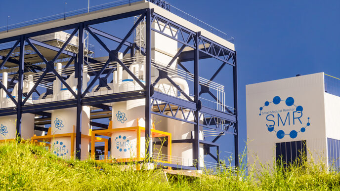 concept of a SMR small modular nuclear reactor power plant on a sunny day SMR is a future energy concept 3d rendering | Meridian Source