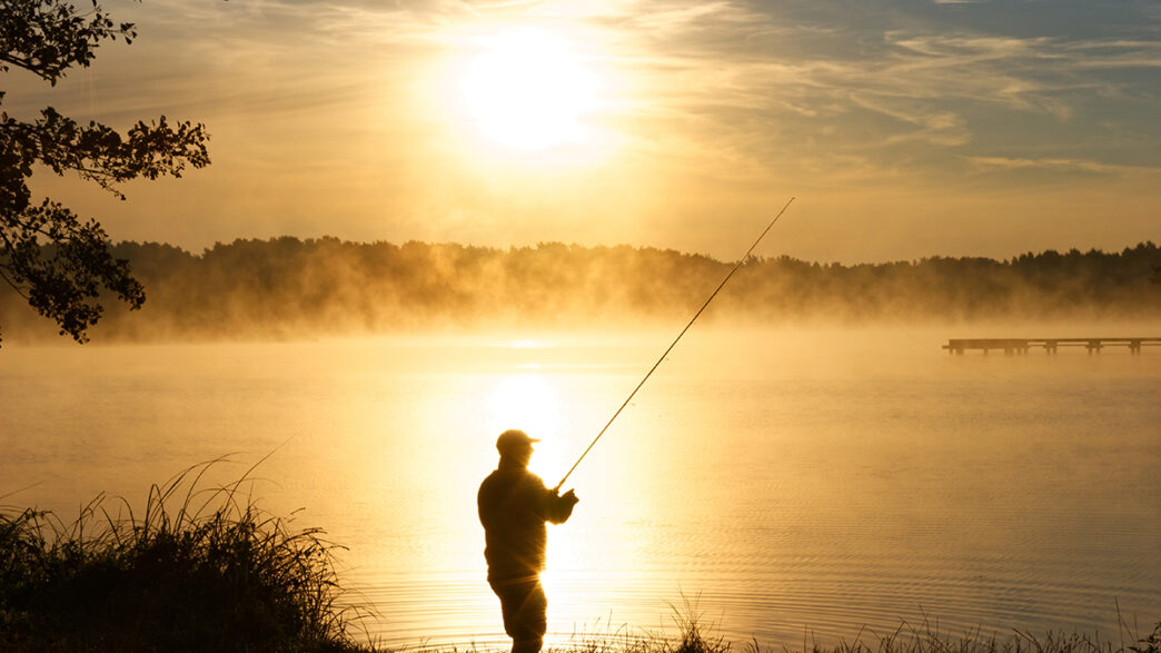 Silhouette of fisherman during foggy sunrise | Meridian Source