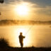Silhouette of fisherman during foggy sunrise | Meridian Source