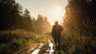 Silhouetted of a hunter with shotgun at beautiful sunset | Meridian Source