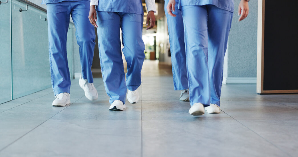 Legs people and nurses walking in hospital for staff duty shift change and medical services Group employees and team in lobby for patient care healthcare treatment and ward round for procedure | Meridian Source