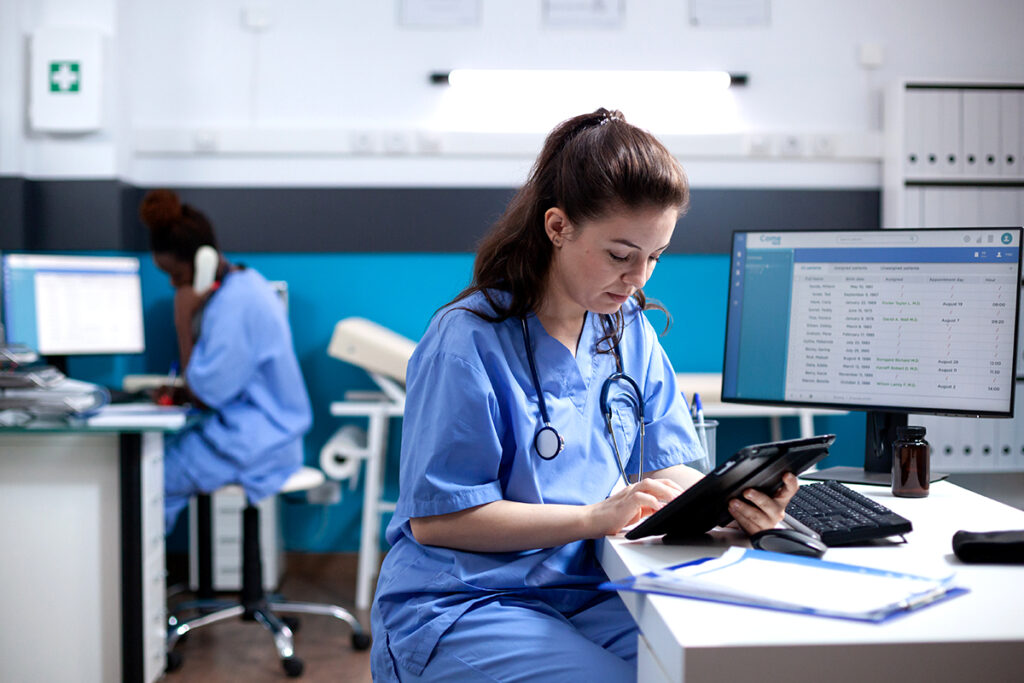 Nurse checking appointments on tablet | Meridian Source trusted