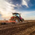Tractor cultivating field at spring | Meridian Source
