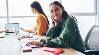 Portrait of cheerful caucasian woman learning via laptop compute | Meridian Source
