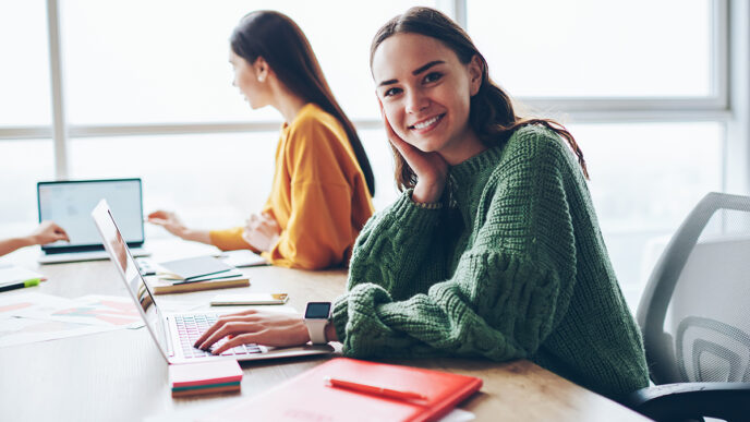 Portrait of cheerful caucasian woman learning via laptop compute | Meridian Source