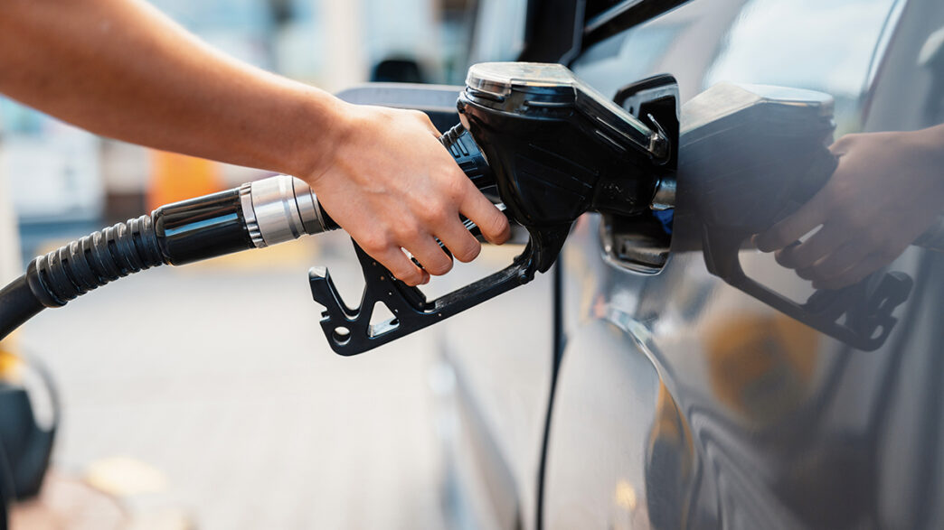 Closeup of woman pumping gasoline fuel in car at gas station Pe | Meridian Source