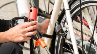 Businesswomans Hand Locking Up Her Bicycle | Meridian Source