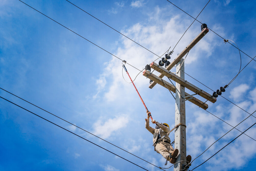 The power lineman use clamp stick insulated tool to closing a | Meridian Source