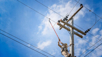 The power lineman use clamp stick insulated tool to closing a | Meridian Source
