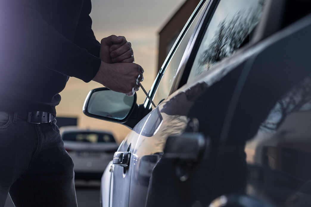 Auto thief in black balaclava trying to break into car | Meridian Source