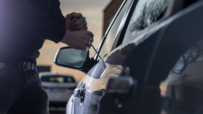 Auto thief in black balaclava trying to break into car | Meridian Source