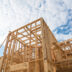 Close-up new stick built home under construction under blue sky | Meridian Source