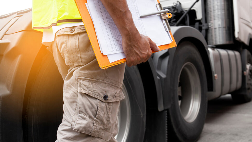 truck driver hand holding clipboard inspecting safety daily chec | Meridian Source